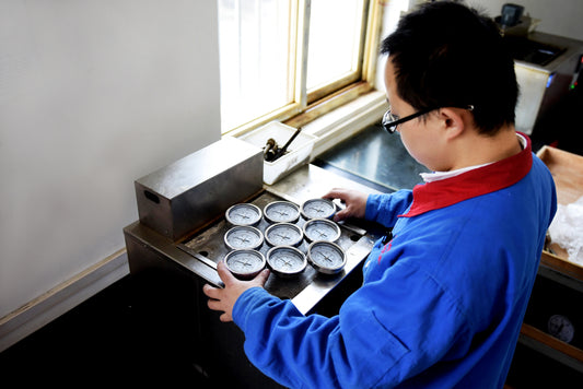 An Engineer performing batch calibration test for thermometers.